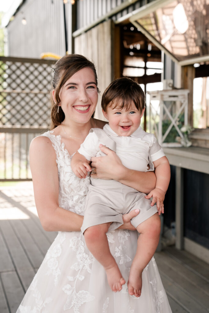 bride with 10 month old son ring bearer summer wedding