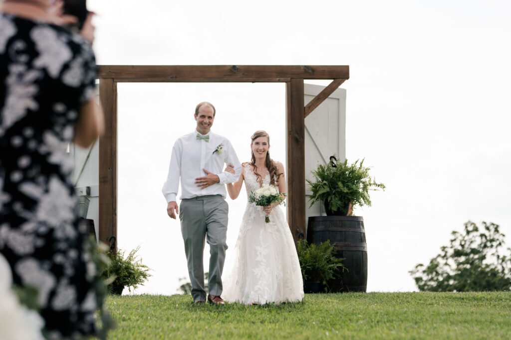 Bride walking down the aisle with father 