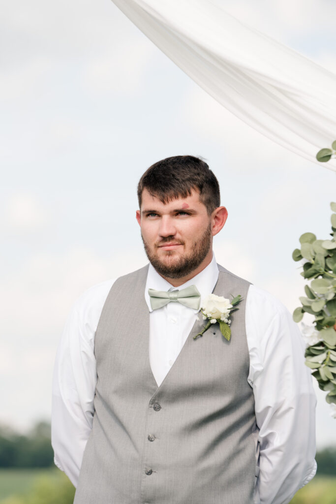 photo of groom as bride walks down the aisle