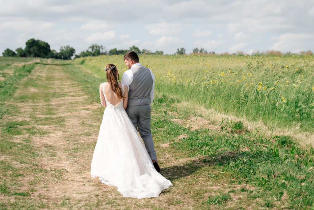 Summer wedding bride and groom in sunflower field 