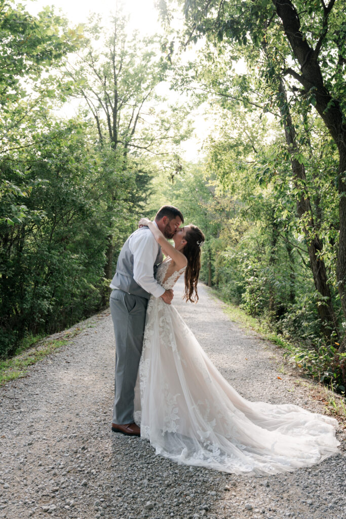 bride and groom on gravel road 