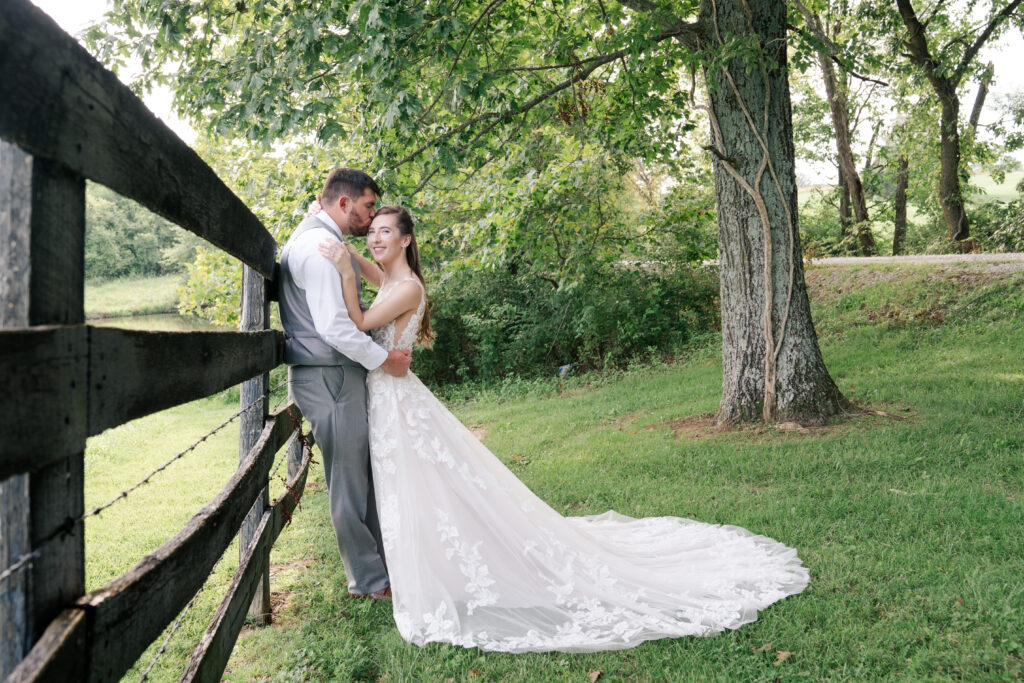 bride and groom near fence 