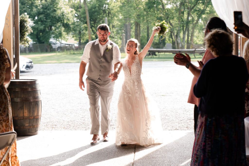 bride and groom entering wedding reception 