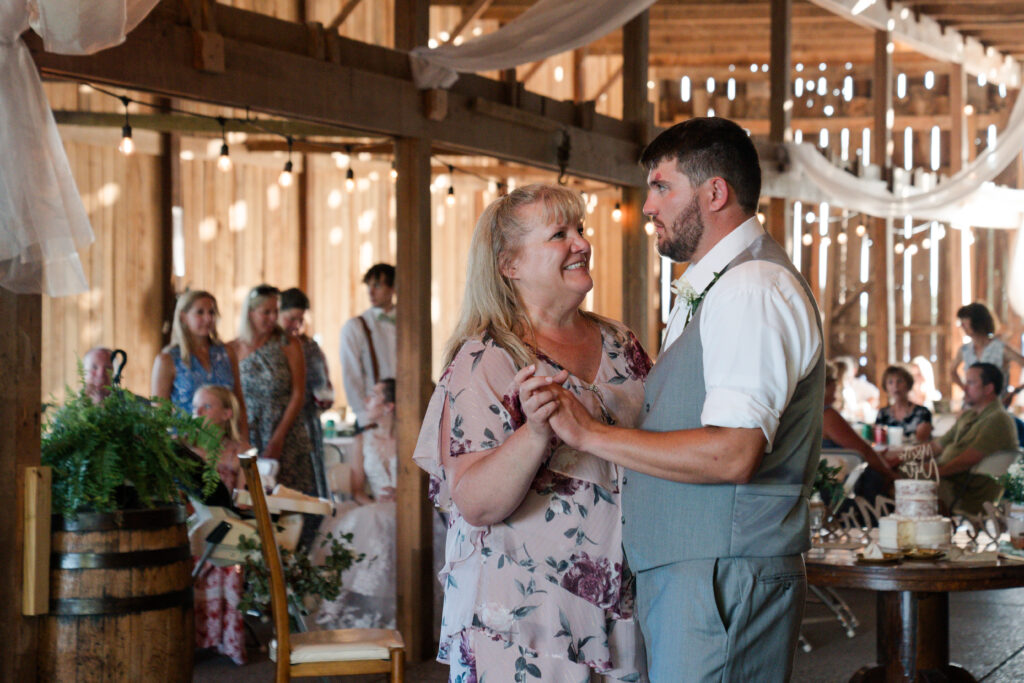 mother and son dance together at wedding