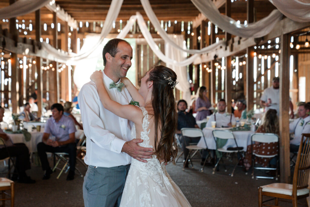 father and daughter dance together at wedding