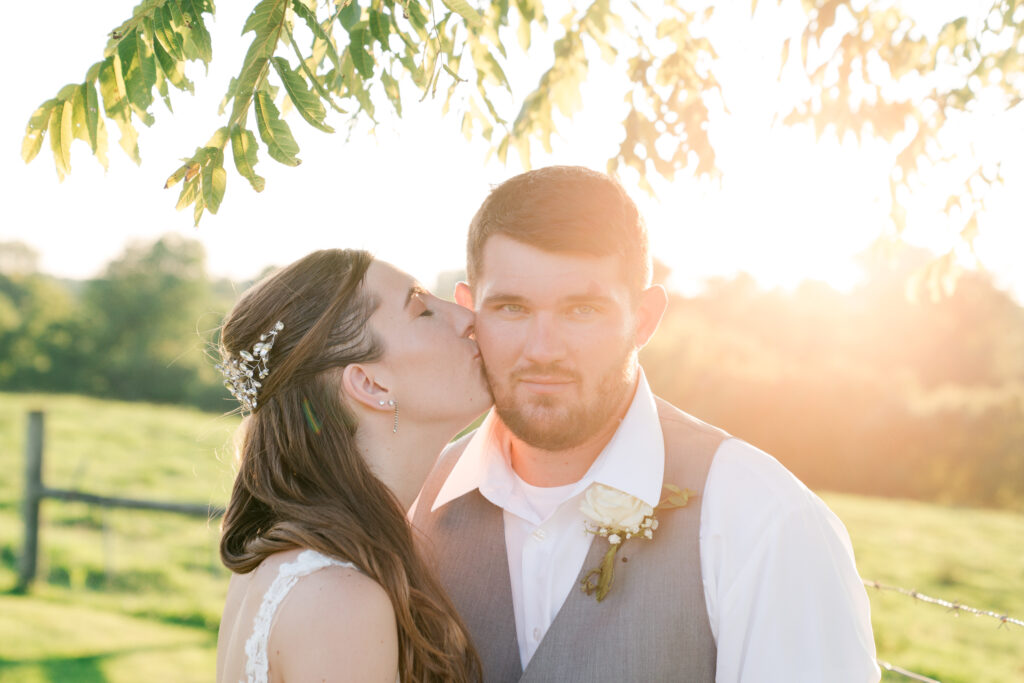 Louisville Wedding Photographer sunset photo bride kisses groom's cheek 