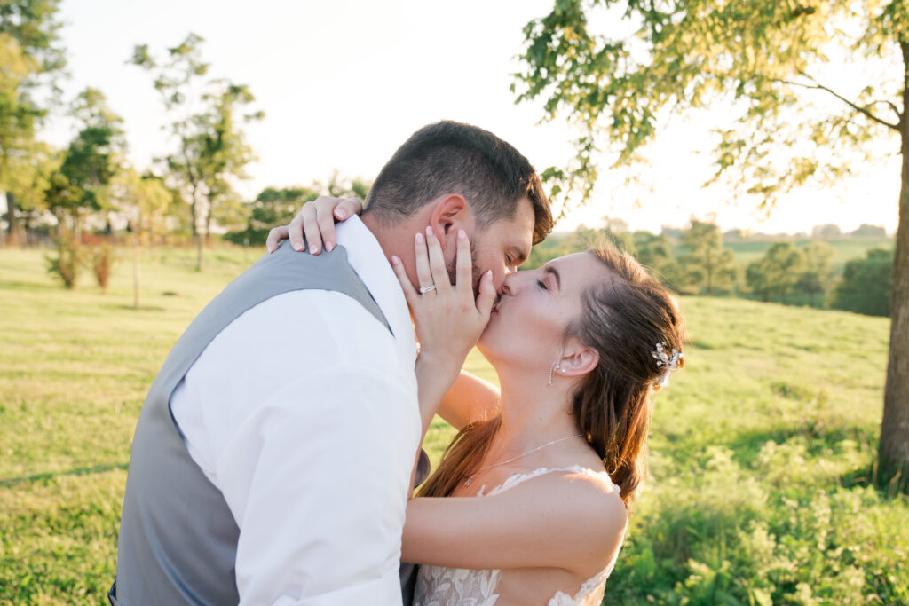 golden hour bride and groom kiss summer wedding