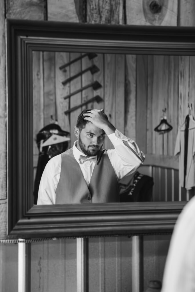 black and white photo groom getting ready on wedding day